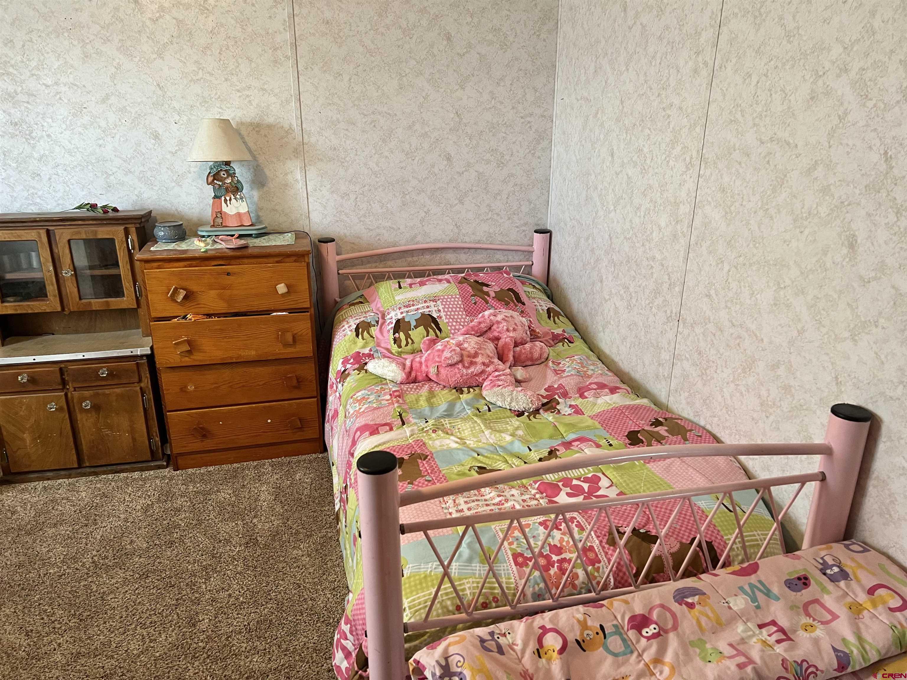 7692 6150th Road Montrose, CO 81401 - Photo 7 of 17 a bedroom with a bed and wooden floor