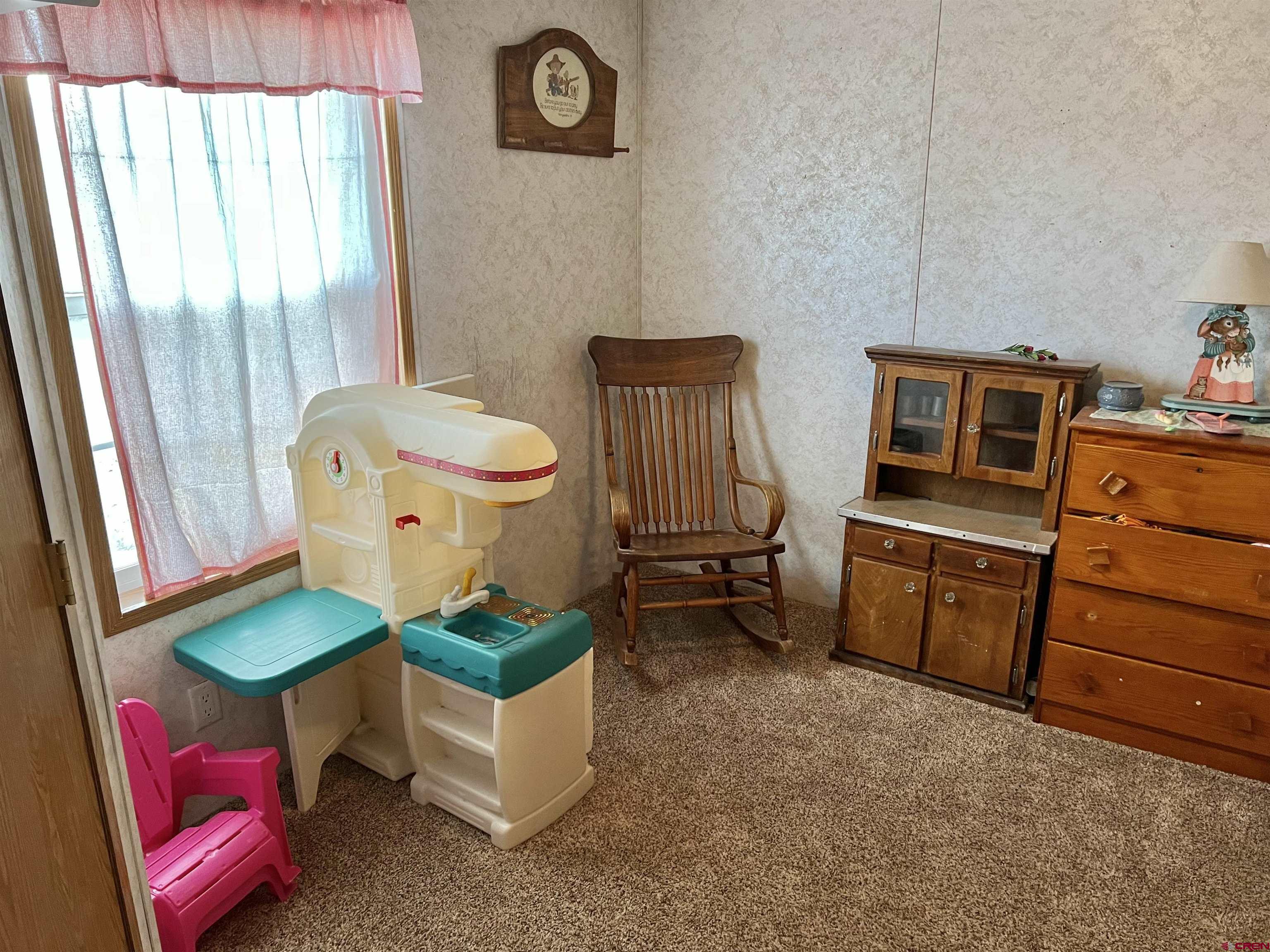 7692 6150th Road Montrose, CO 81401 - Photo 8 of 17 a room with furniture and a mirror