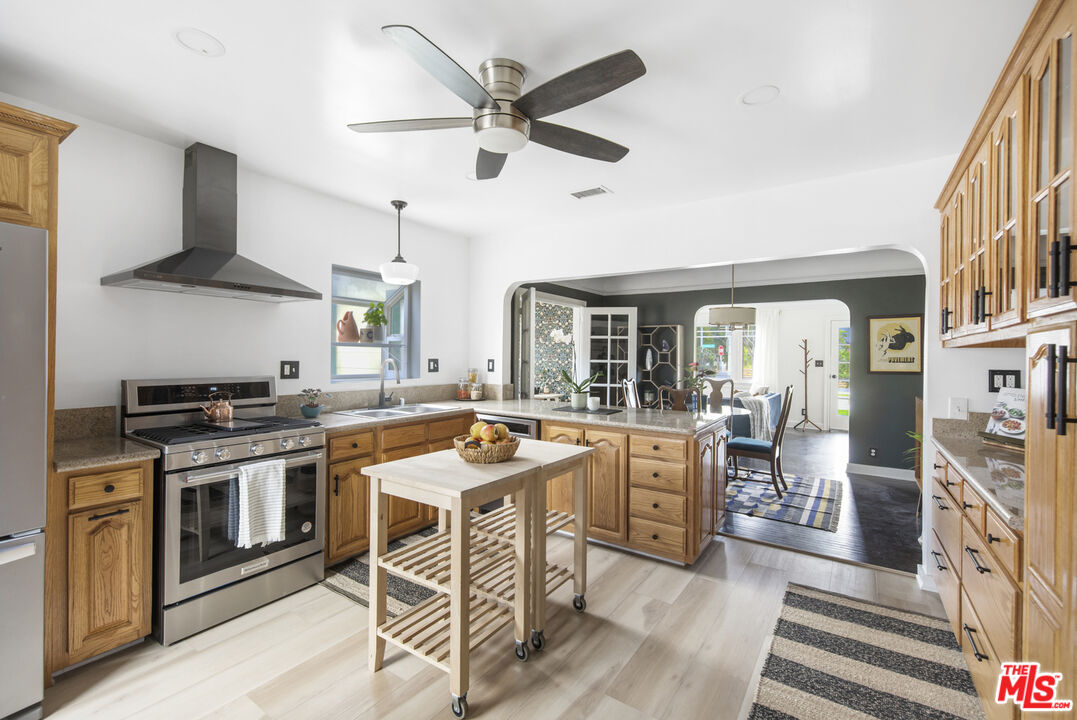 2035 Summit Avenue Pasadena, CA 91103 - Photo 11 of 27 a kitchen with a stove a sink and a refrigerator