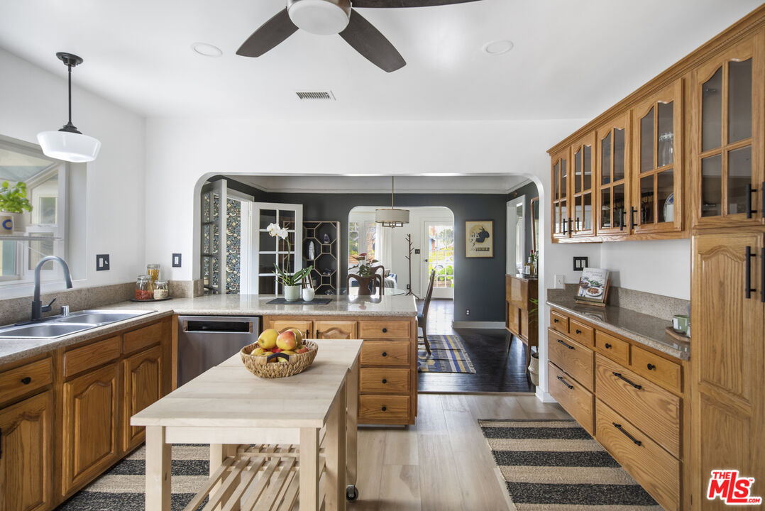 2035 Summit Avenue Pasadena, CA 91103 - Photo 12 of 27 a large kitchen with stainless steel appliances kitchen island granite countertop a sink and cabinets