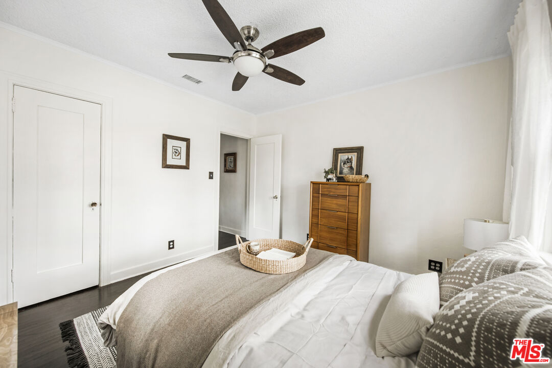 2035 Summit Avenue Pasadena, CA 91103 - Photo 16 of 27 a bedroom with a bed and a chandelier