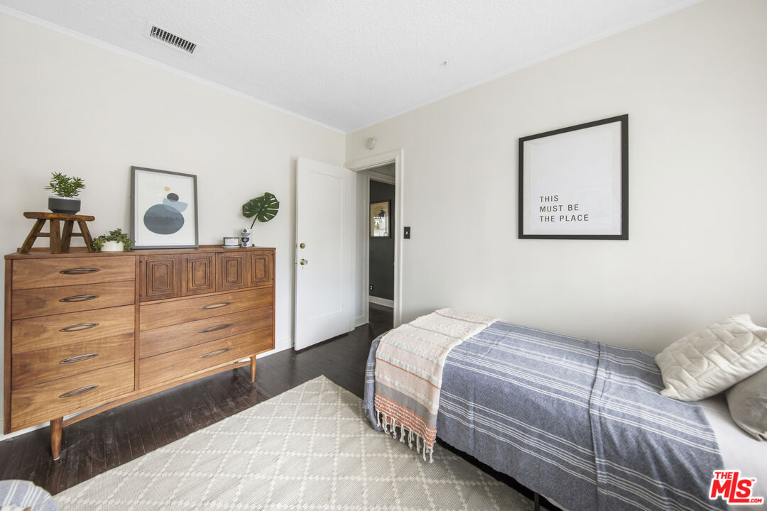 2035 Summit Avenue Pasadena, CA 91103 - Photo 20 of 27 a bedroom with a bed and a dresser