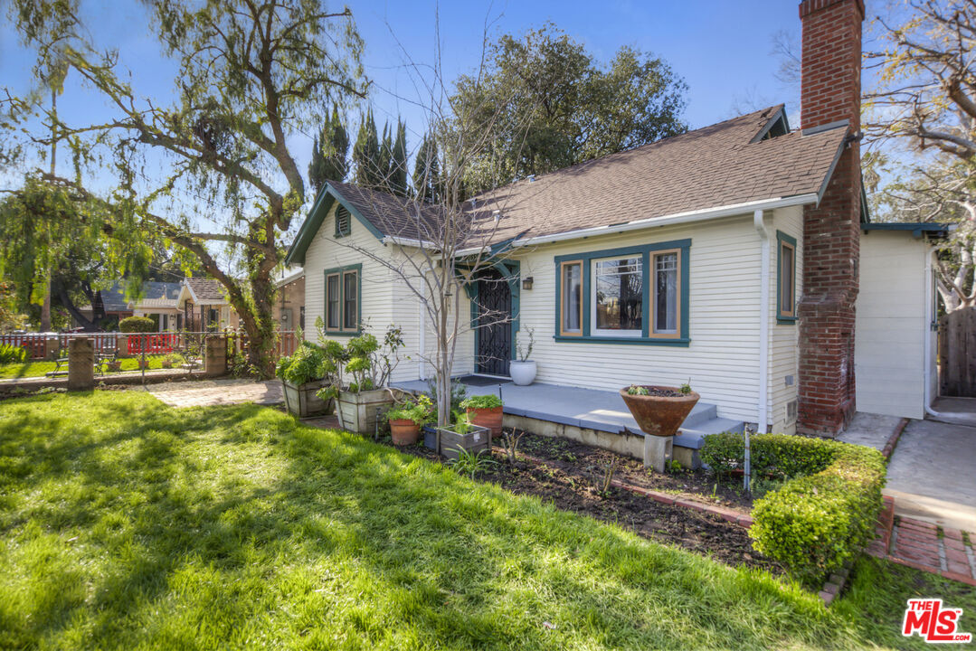 2035 Summit Avenue Pasadena, CA 91103 - Photo 2 of 27 a front view of a house with garden