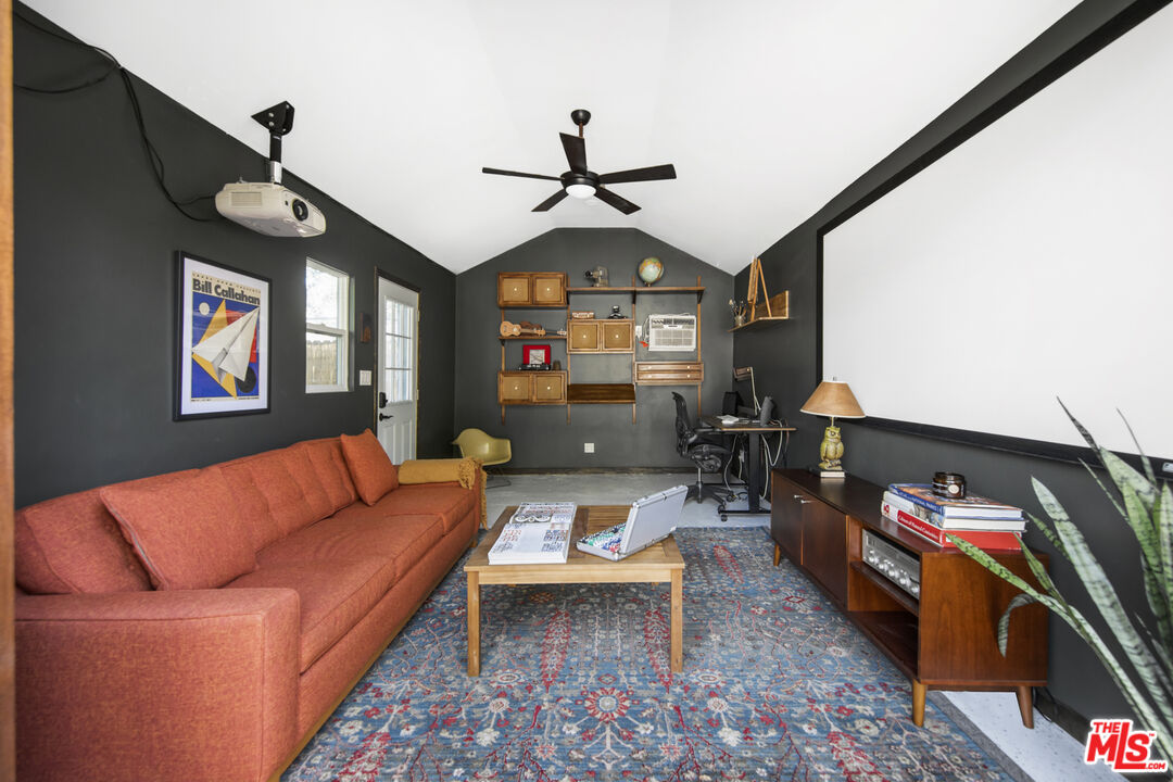 2035 Summit Avenue Pasadena, CA 91103 - Photo 26 of 27 a living room with furniture a rug and a chandelier