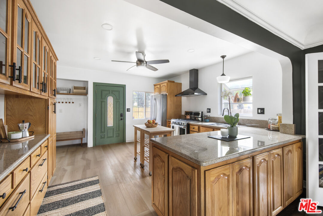 2035 Summit Avenue Pasadena, CA 91103 - Photo 9 of 27 a kitchen with granite countertop a sink stove and cabinets