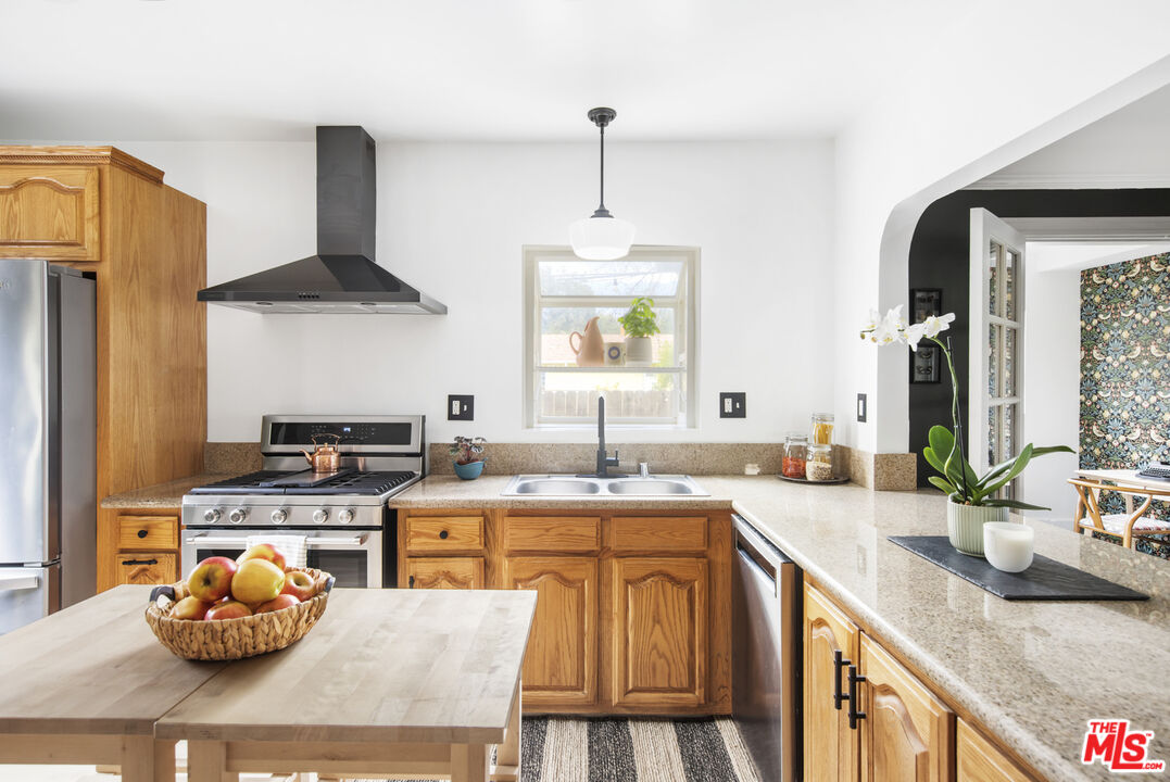 2035 Summit Avenue Pasadena, CA 91103 - Photo 10 of 27 a kitchen with stainless steel appliances granite countertop a sink stove and refrigerator