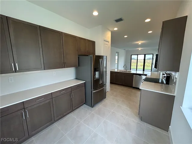a kitchen with stainless steel appliances a refrigerator and a sink