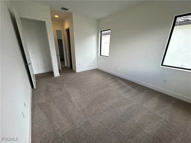 an empty room with an entrance to other room