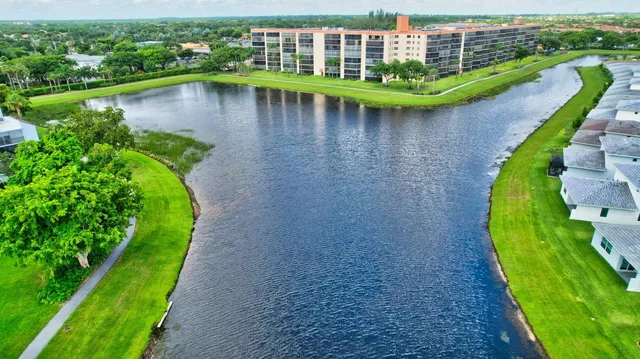 an aerial view of residential houses with outdoor space and street view