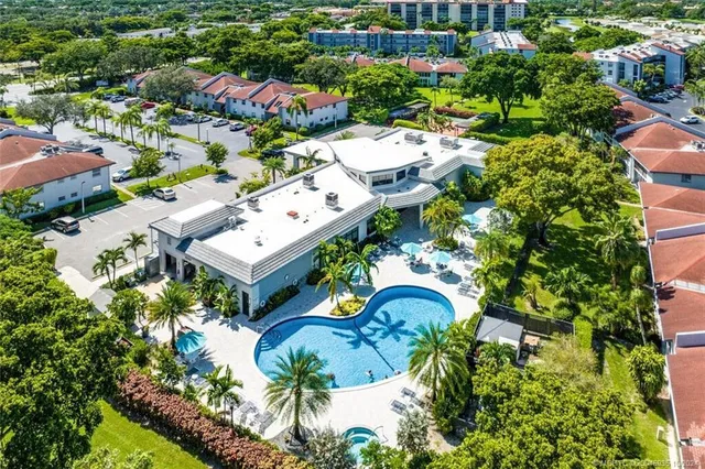 a view of a house with swimming pool and sitting area