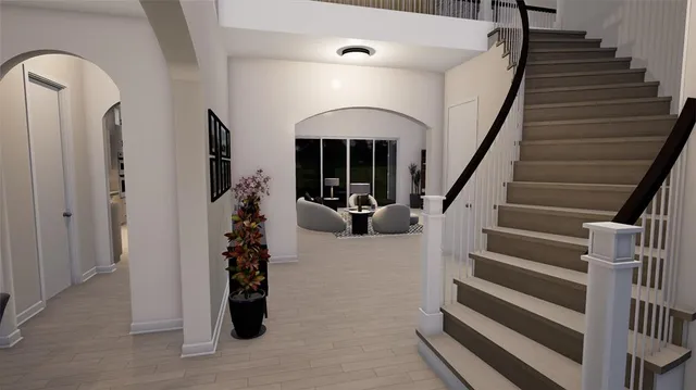 a view of entryway and hall with wooden floor