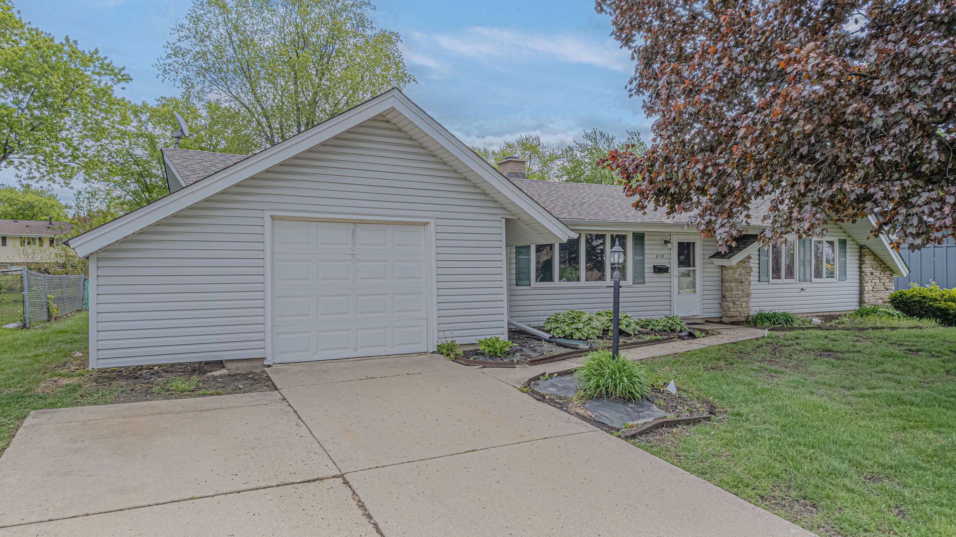 635 Springinsguth Road Schaumburg, IL 60193 - Photo 1 of 26 a view of a house with a yard and potted plants