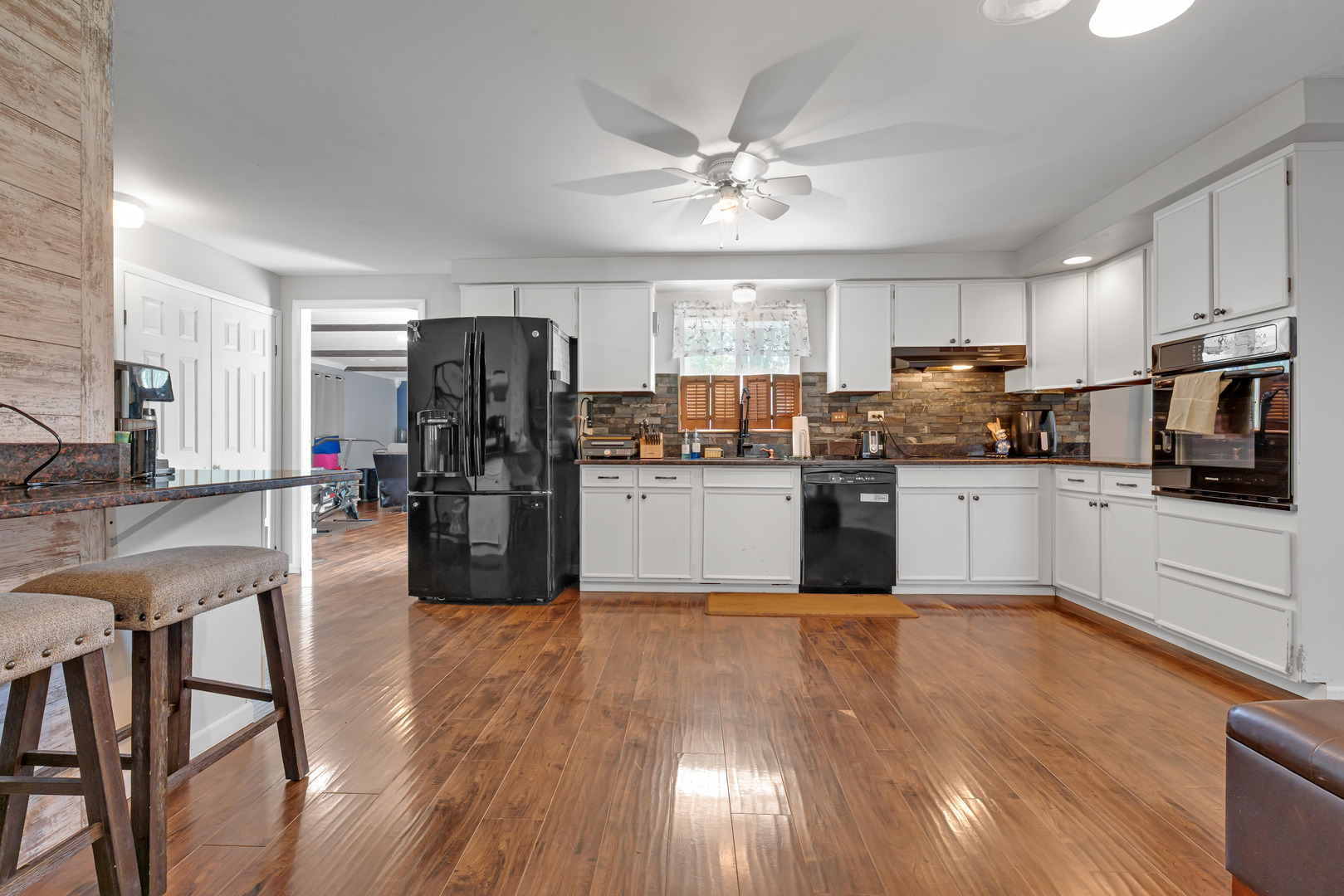 635 Springinsguth Road Schaumburg, IL 60193 - Photo 5 of 26 a kitchen with stainless steel appliances a microwave a stove a sink dishwasher a refrigerator and white cabinets with wooden floor