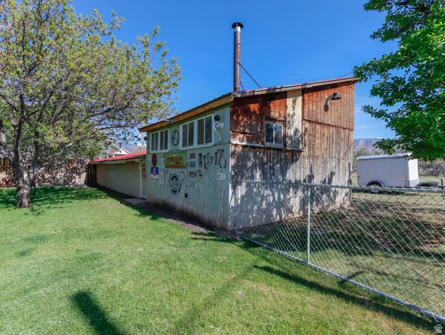 155 West Center Street Fillmore, UT 84631 - Photo 77 of 86 Detached structure featuring wood siding, multiple windows, and an exterior chimney