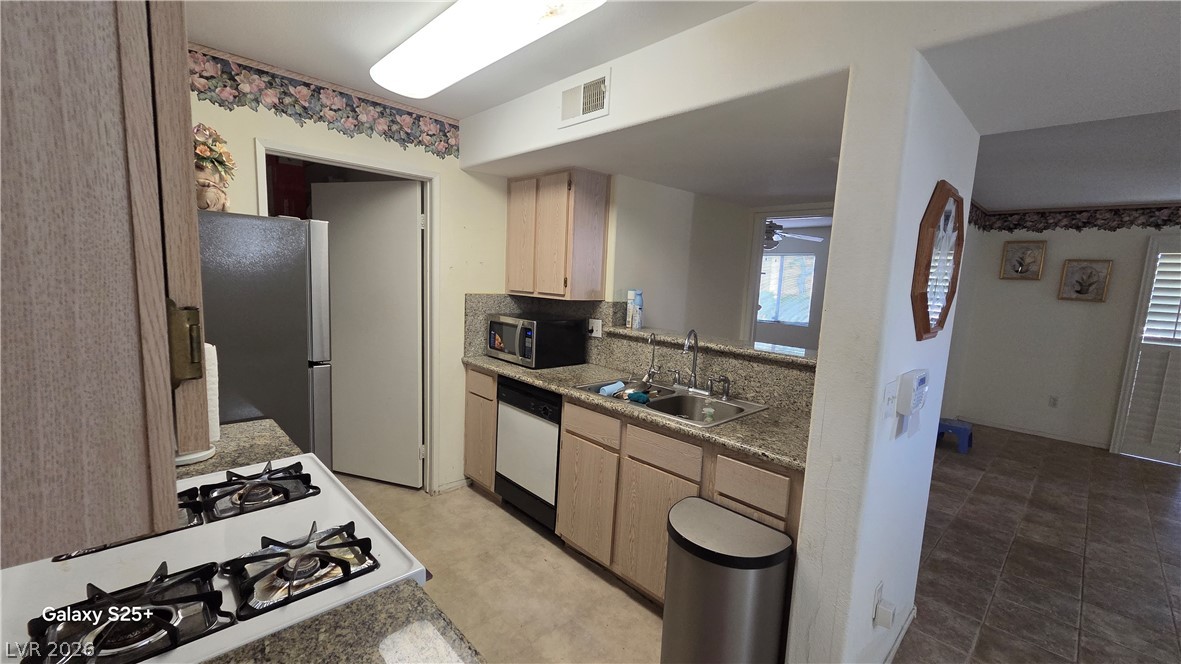 7885 West Flamingo Road, Unit 1008 Las Vegas, NV 89147 - Photo 19 of 29 A functional kitchen features generous counter space and seamless connection to adjacent living areas.