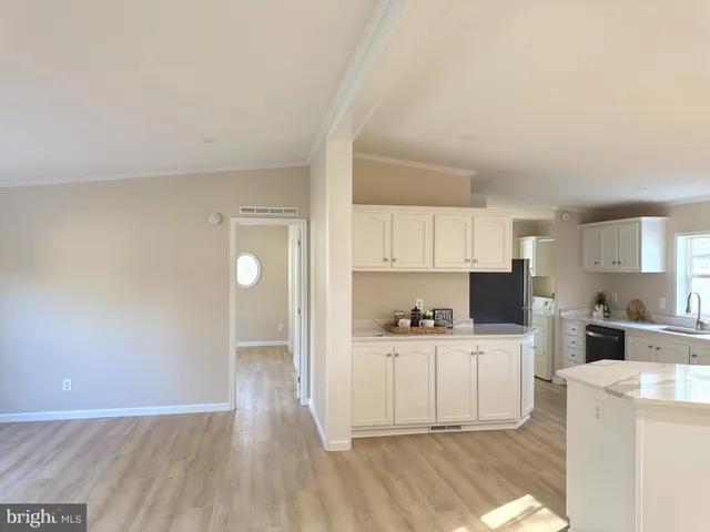 a view of a kitchen with a sink cabinets and a wooden floor