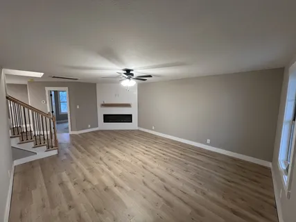 a view of a kitchen with furniture and wooden floor