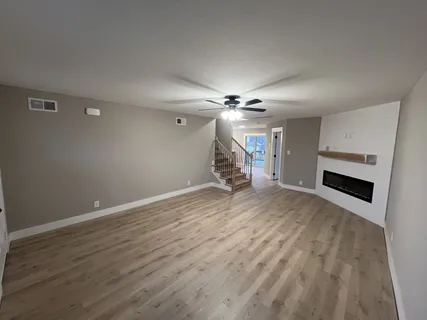 a kitchen with stainless steel appliances a sink a stove a refrigerator cabinets and a window