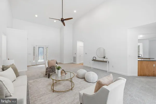 a living room with furniture and kitchen view