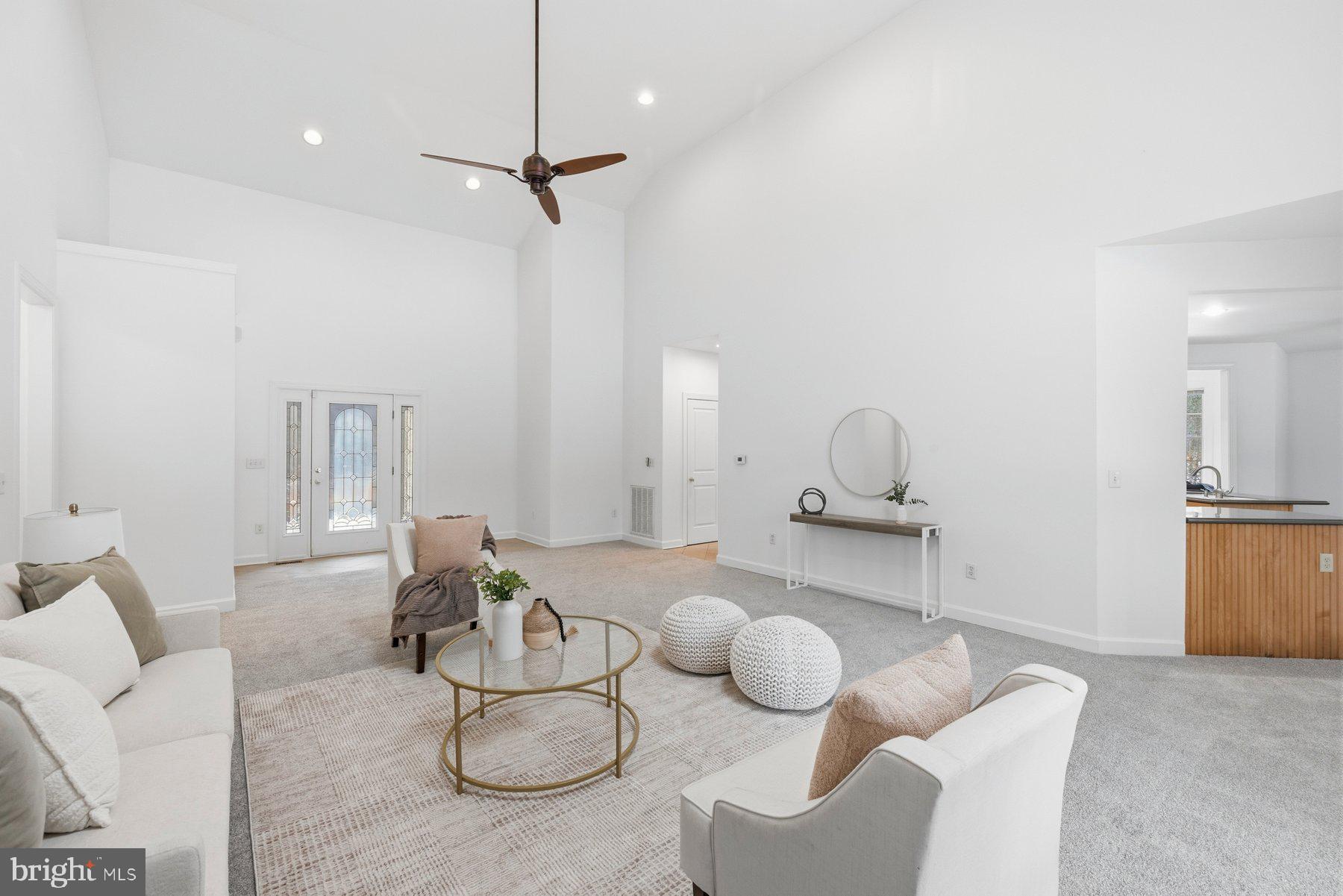 a living room with furniture and kitchen view