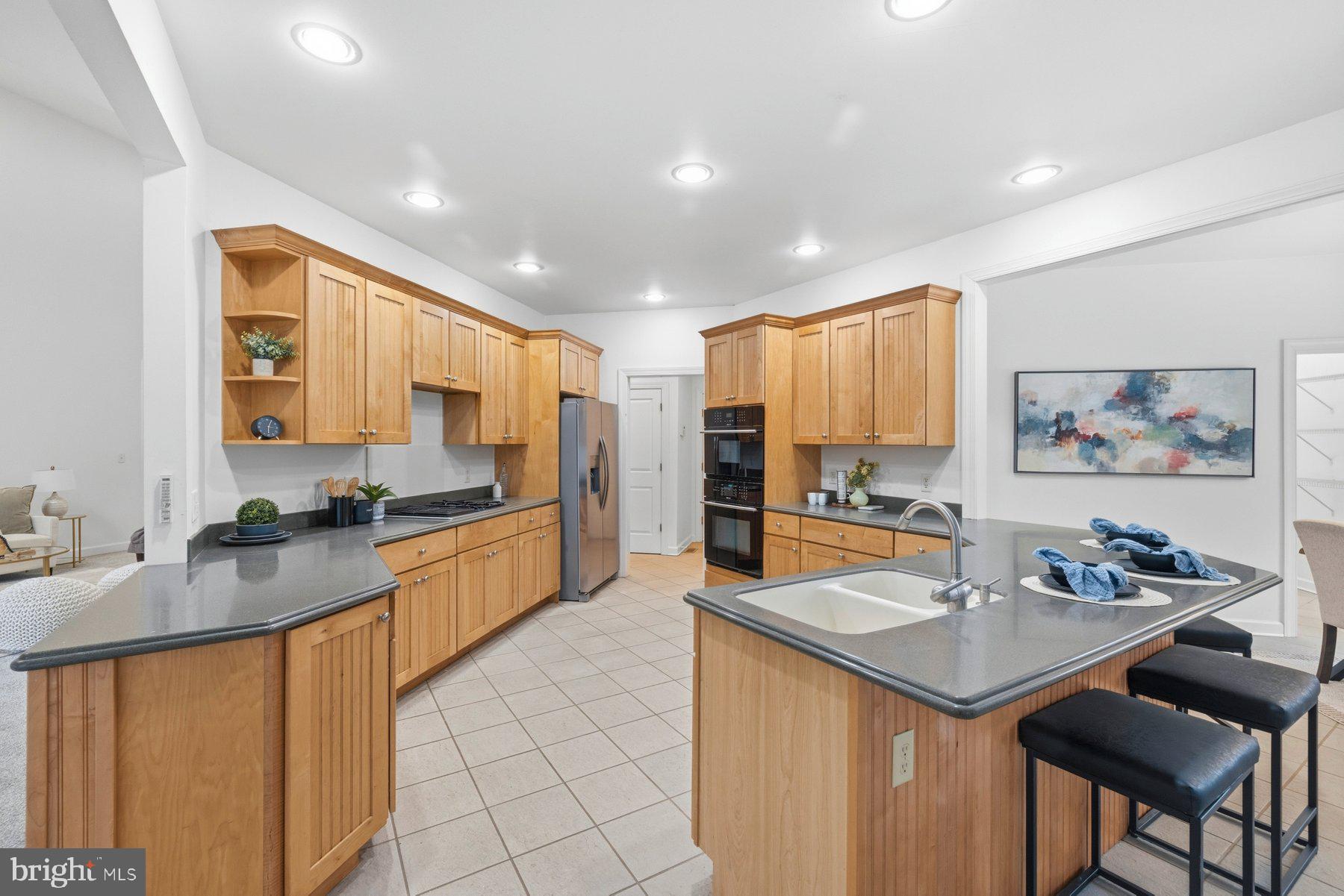 5375 Deale Churchton Road Churchton, MD 20733 - Photo 17 of 47 a large kitchen with kitchen island a large counter top space appliances and a center island