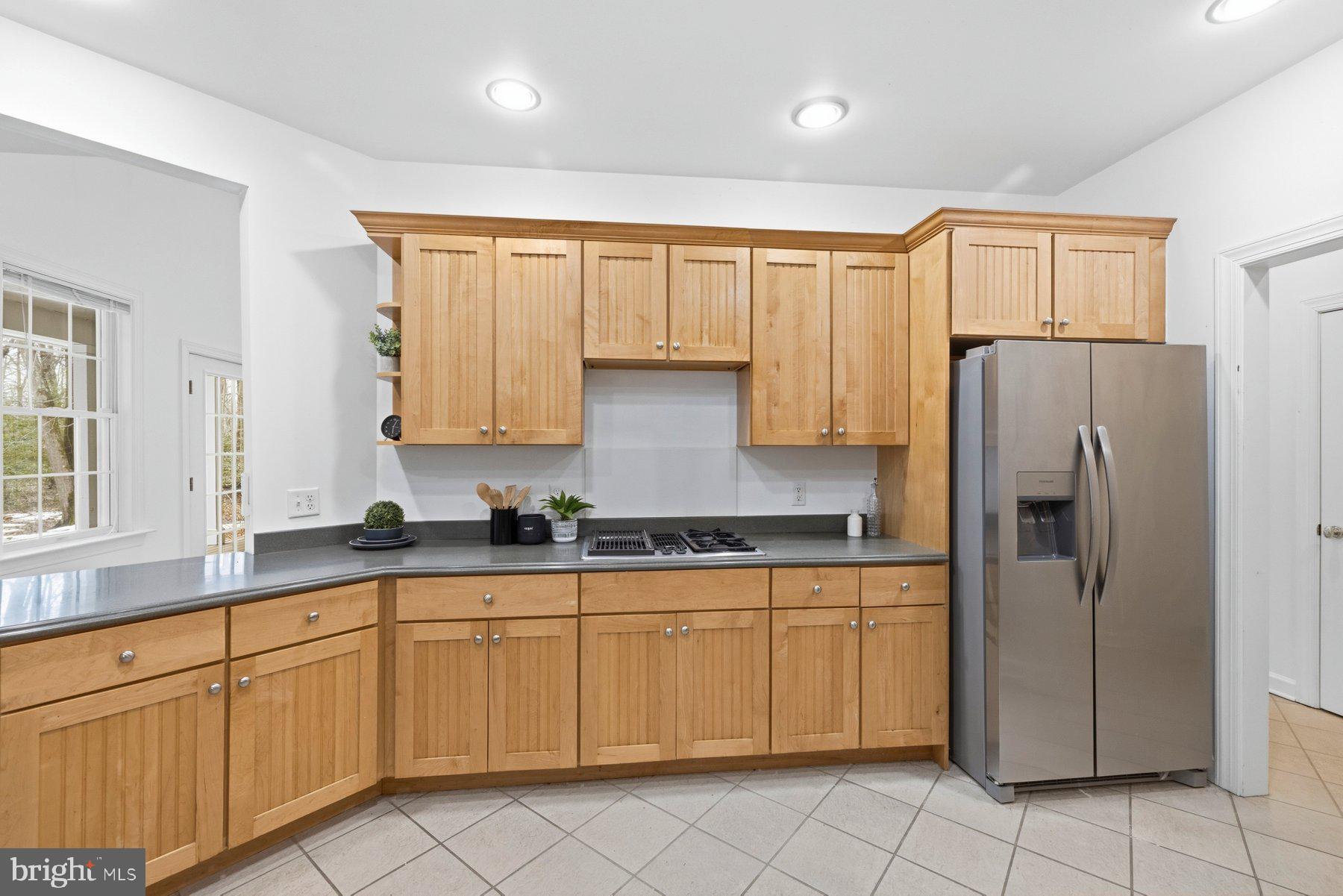 5375 Deale Churchton Road Churchton, MD 20733 - Photo 20 of 47 a kitchen with stainless steel appliances granite countertop a refrigerator sink and cabinets