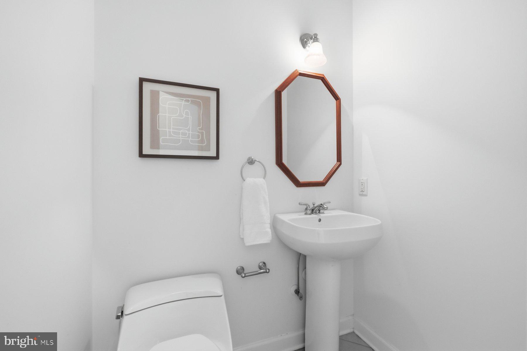 5375 Deale Churchton Road Churchton, MD 20733 - Photo 22 of 47 a bathroom with a toilet sink and mirror