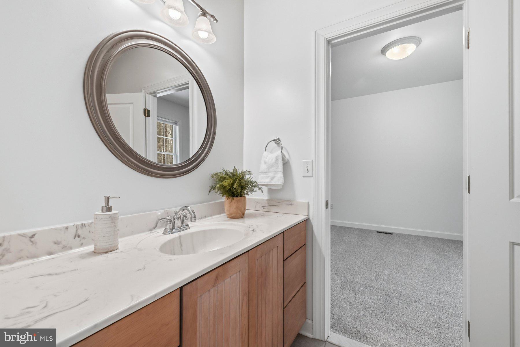 5375 Deale Churchton Road Churchton, MD 20733 - Photo 25 of 47 a bathroom with a granite countertop double vanity sink and a mirror