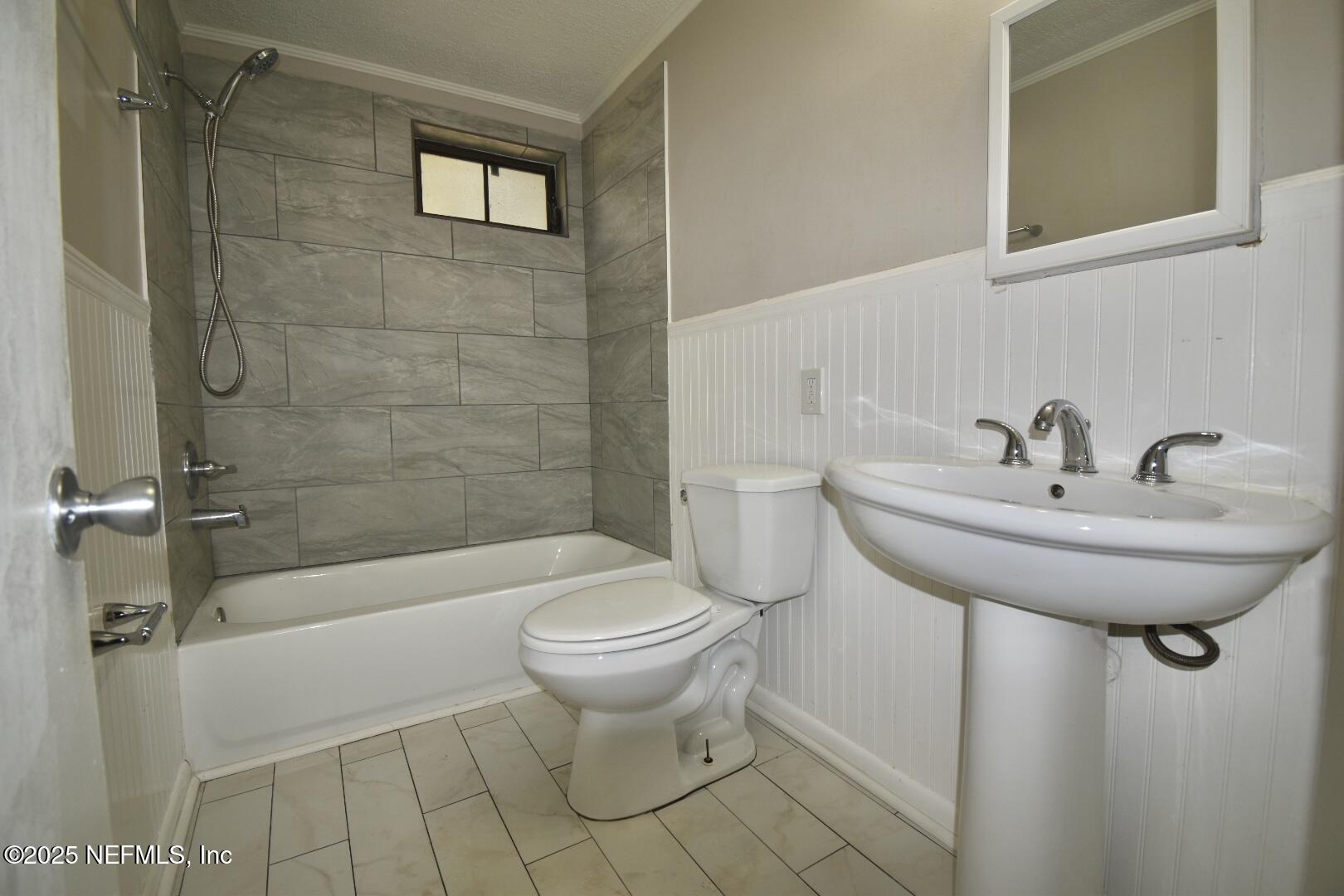 5102 Lambing Road Jacksonville, FL 32210 - Photo 17 of 25 a bathroom with a sink toilet and shower