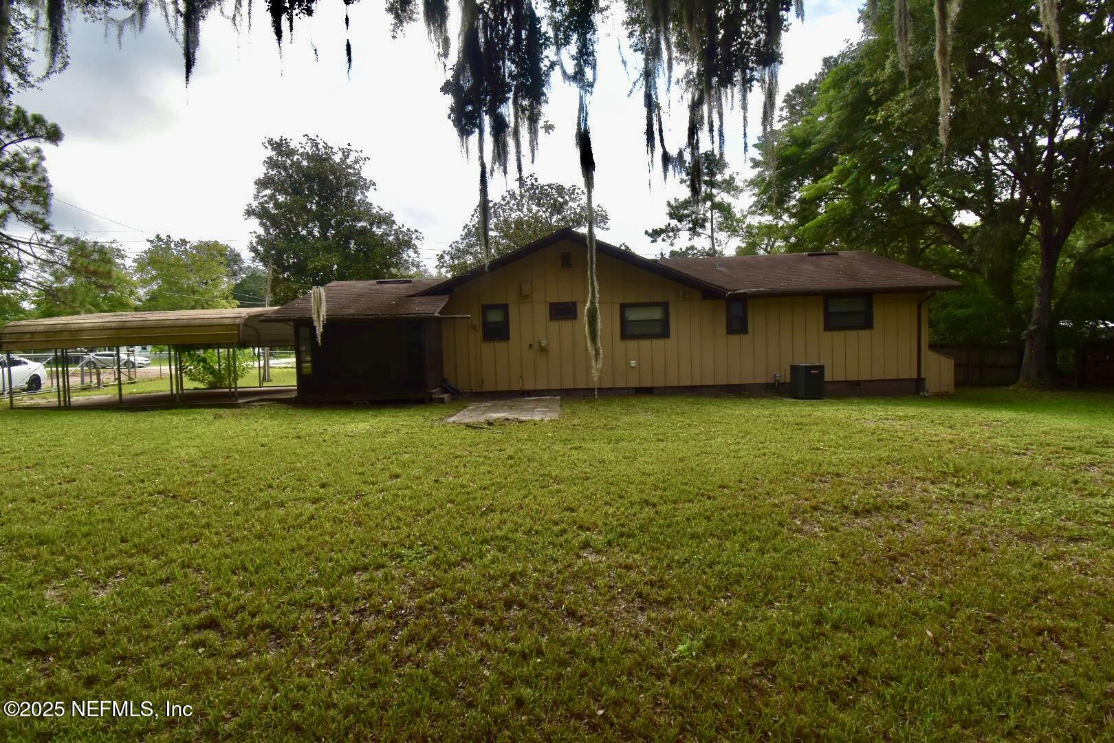 5102 Lambing Road Jacksonville, FL 32210 - Photo 21 of 25 a blue house with a yard
