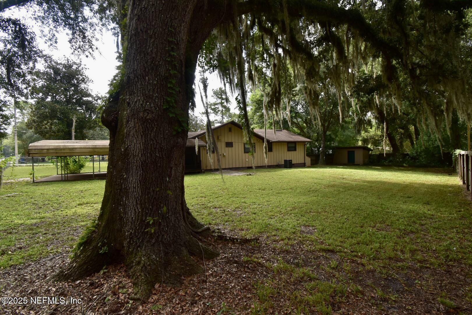 5102 Lambing Road Jacksonville, FL 32210 - Photo 22 of 25 a view of a yard with a house in the background