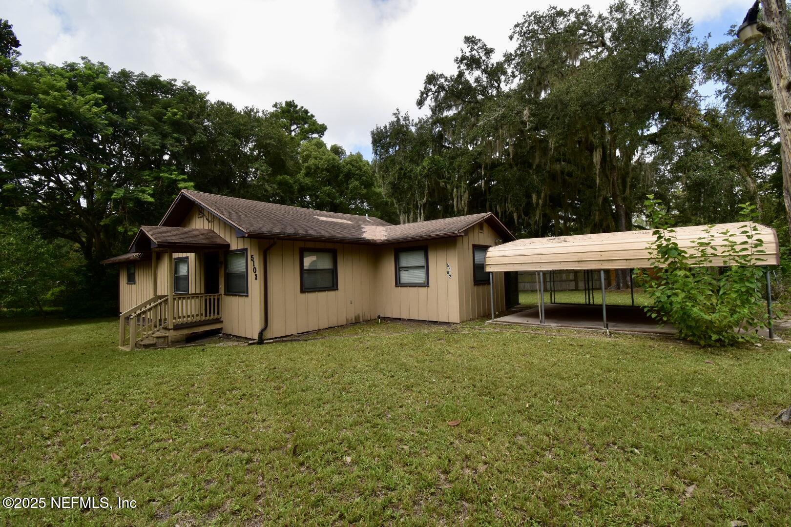 5102 Lambing Road Jacksonville, FL 32210 - Photo 6 of 25 a house that has a big yard with wooden fence