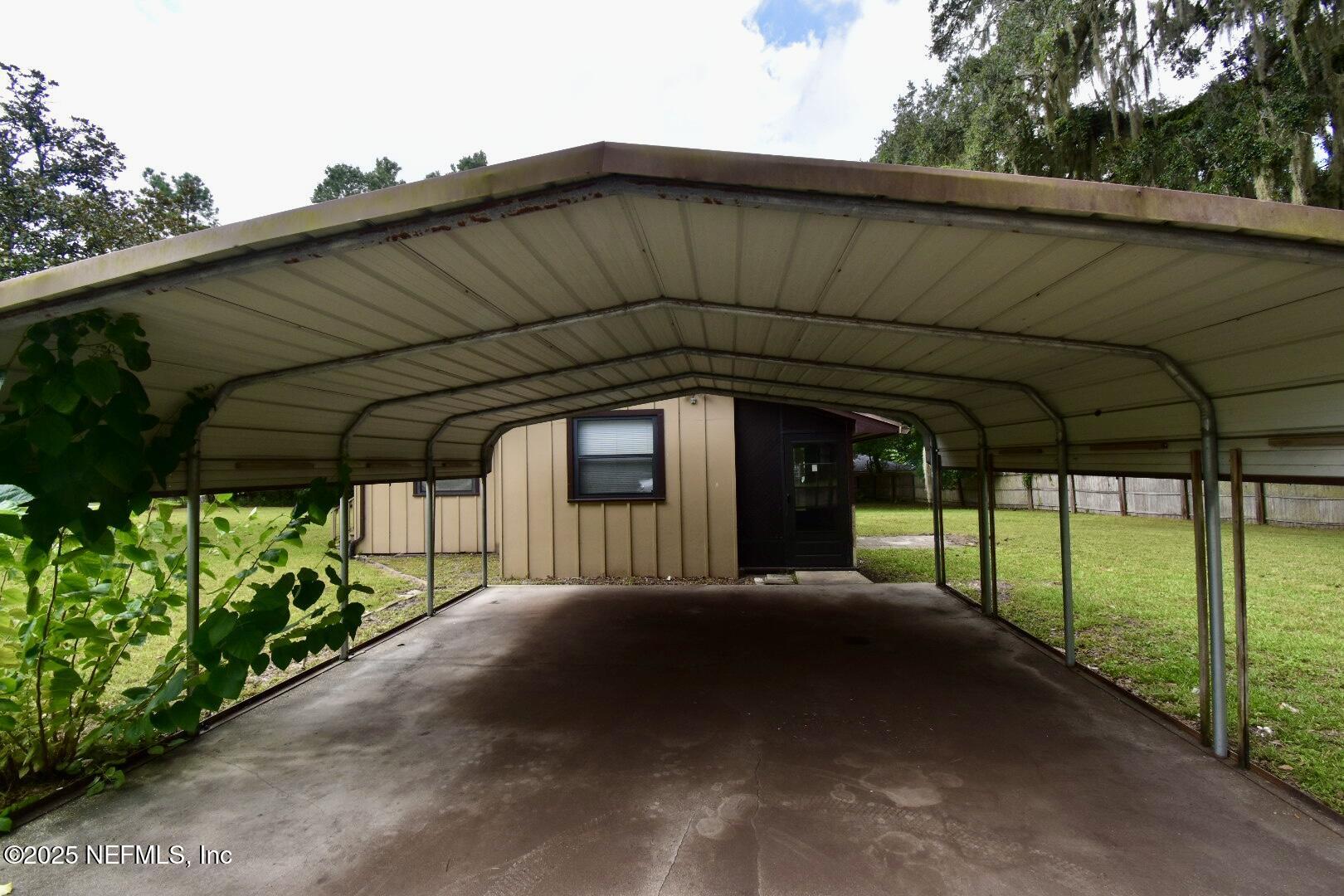 5102 Lambing Road Jacksonville, FL 32210 - Photo 7 of 25 a view of a green house with a small yard