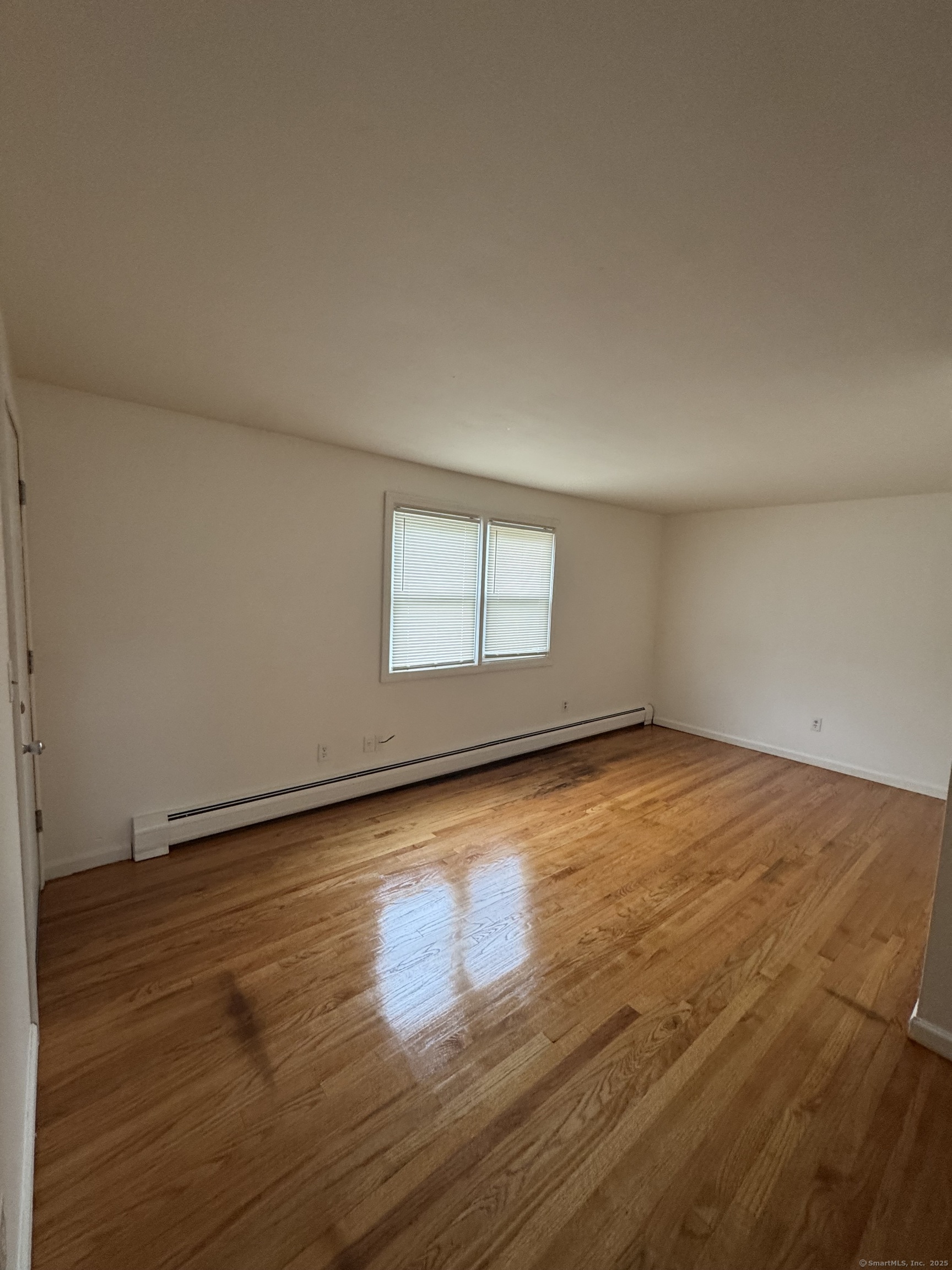 68 Warner Street, Unit B2 Hamden, CT 06514 - Photo 2 of 6 an empty room with wooden floor and windows