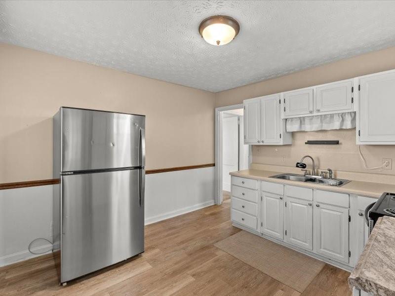 4624 Macland Road Hiram, GA 30141 - Photo 9 of 12 a kitchen with stainless steel appliances a refrigerator sink and cabinets