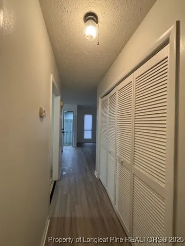 a view of a house with a small yard next to a road