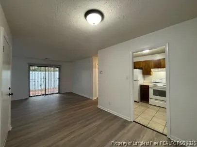 an empty room with wooden floor and a window