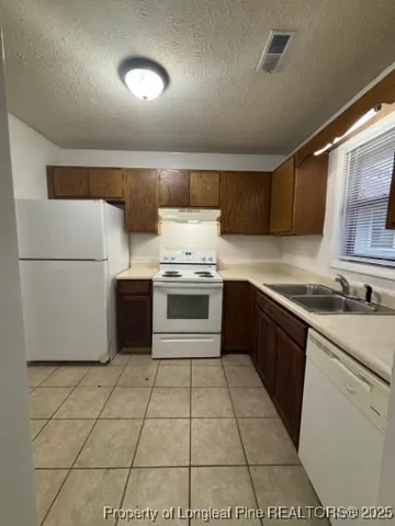 a kitchen with a stove top oven sink and cabinets