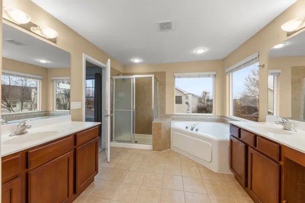 a large bathroom with a large tub shower sink and mirror