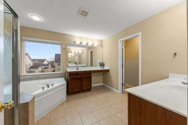 a large bathroom with a large tub and sink