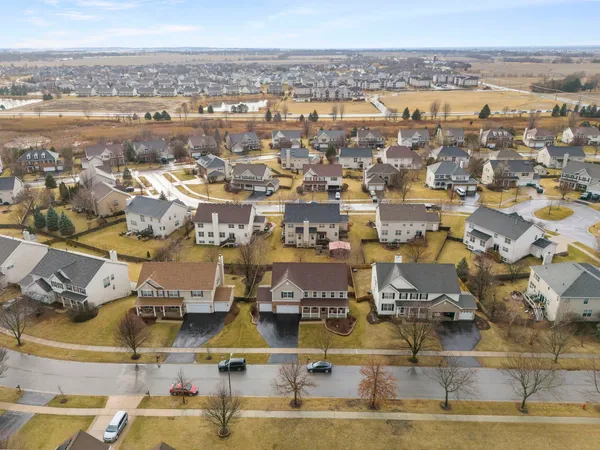 an aerial view of residential building with parking