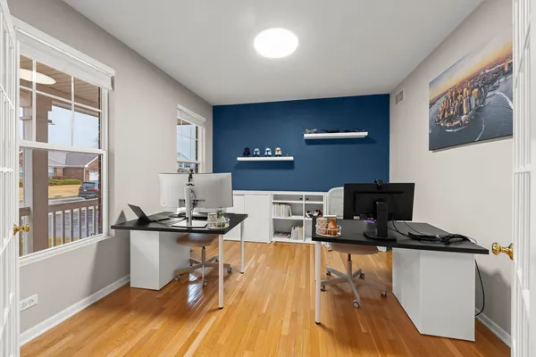 a view of a workspace with furniture and wooden floor