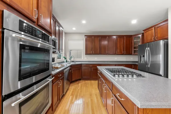a kitchen with stainless steel appliances granite countertop a stove microwave and refrigerator