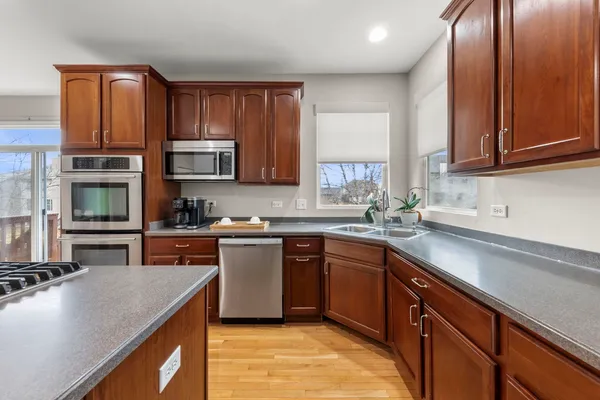 a kitchen with stainless steel appliances granite countertop a sink stove and microwave