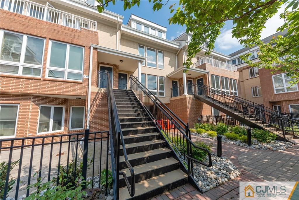 368 Rector Street, Unit 411 Perth Amboy, NJ 08861 - Photo 1 of 14 front view of a building with a small yard