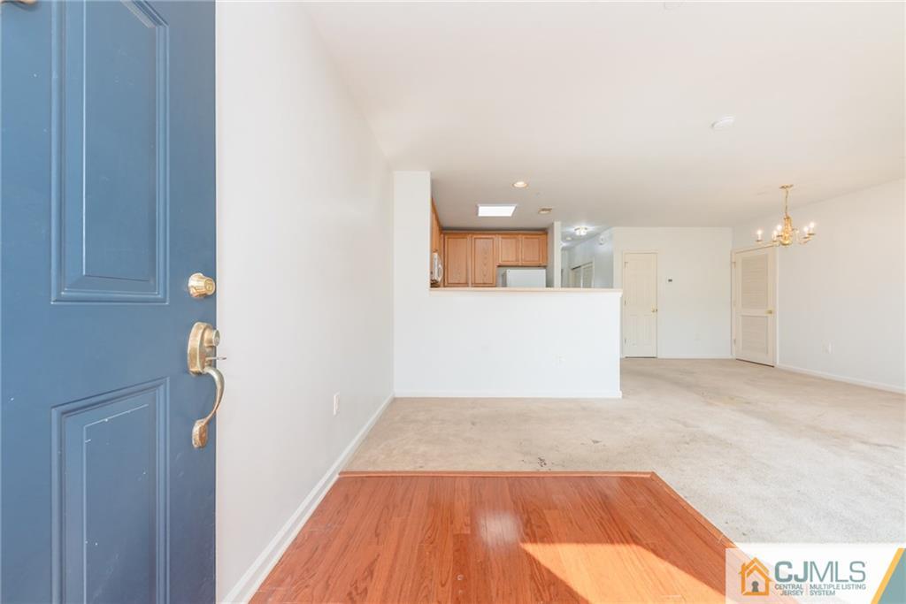 368 Rector Street, Unit 411 Perth Amboy, NJ 08861 - Photo 3 of 14 a view of a room with wooden floor and a ceiling fan