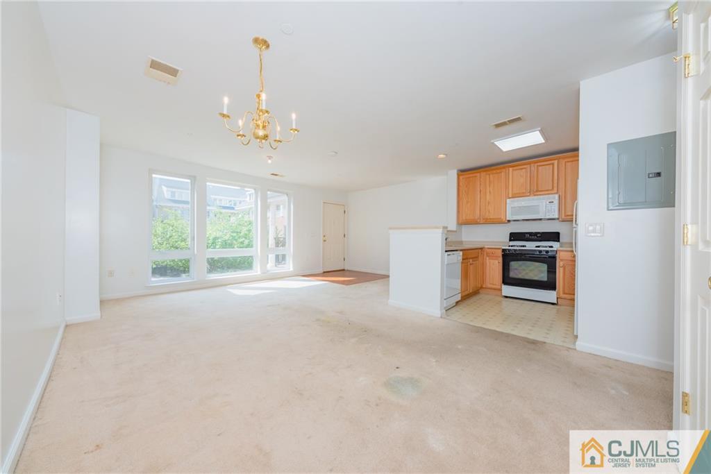 368 Rector Street, Unit 411 Perth Amboy, NJ 08861 - Photo 5 of 14 a view of a kitchen with a sink and dishwasher cabinets