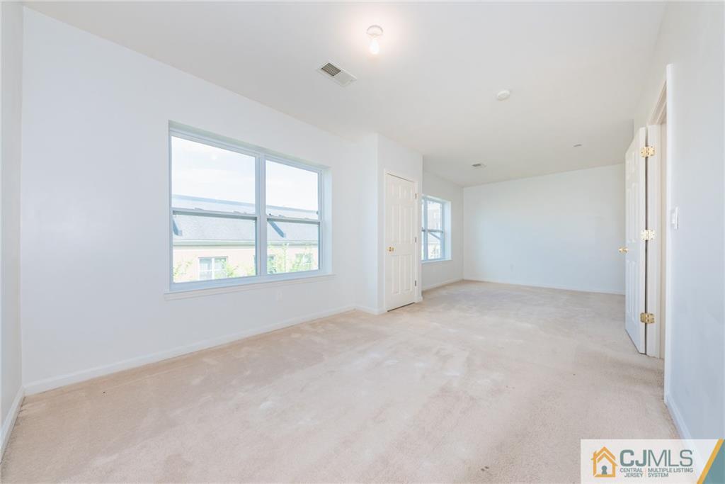 368 Rector Street, Unit 411 Perth Amboy, NJ 08861 - Photo 9 of 14 an empty room with windows