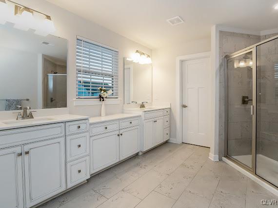 4020 Walter Road Bethlehem, PA 18020 - Photo 37 of 54 a spacious bathroom with a double vanity sink a large mirror and shower