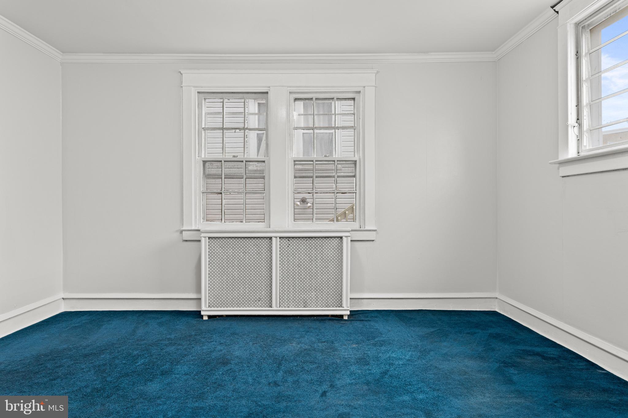 221 Barrington Road Upper Darby, PA 19082 - Photo 9 of 29 an empty room with wooden floor and windows